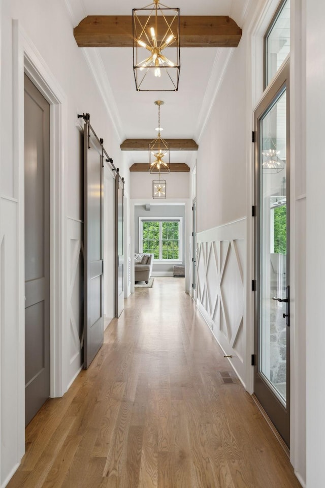 8118 Heirloom Blvd, College Grove, TN 37046 - hallway featuring a barn door, a chandelier, wood finished floors, crown molding, and beam ceiling