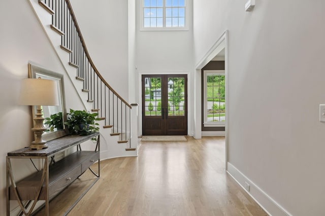 8118 Heirloom Blvd, College Grove, TN 37046 - entryway with stairway, wood finished floors, a towering ceiling, baseboards, and french doors