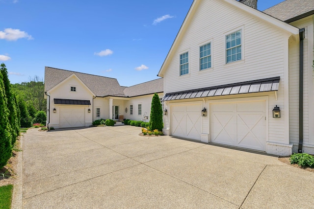 8118 Heirloom Blvd, College Grove, TN 37046 - modern farmhouse with concrete driveway, a standing seam roof, a garage, and metal roof
