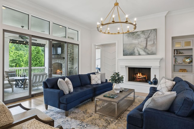 8118 Heirloom Blvd, College Grove, TN 37046 - living room with a lit fireplace, crown molding, wood finished floors, and a chandelier