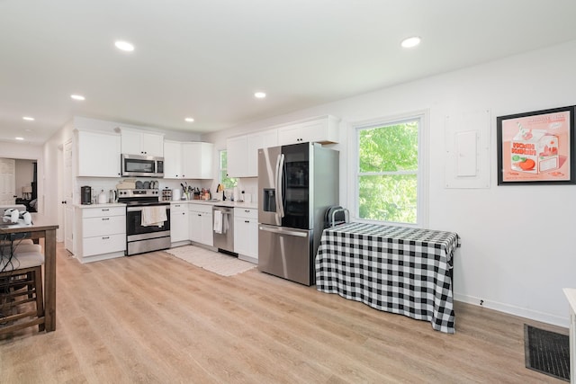 106 Aaron Dr, Burns, TN 37029 - kitchen with stainless steel appliances, light wood-type flooring, light countertops, white cabinets, and recessed lighting