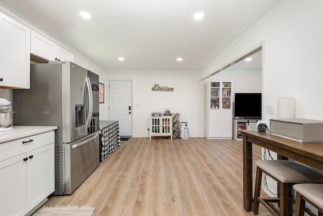 106 Aaron Dr, Burns, TN 37029 - kitchen featuring stainless steel fridge with ice dispenser, white cabinets, light wood-style floors, recessed lighting, and light countertops