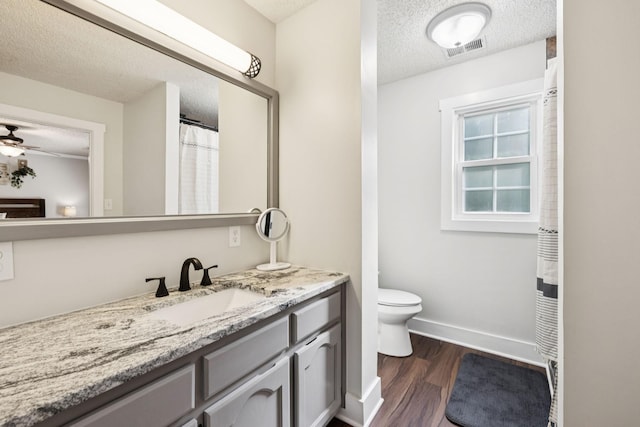 345 Big Spring Hollow Rd, Pulaski, TN 38478 - bathroom with a textured ceiling, vanity, toilet, wood finished floors, and baseboards