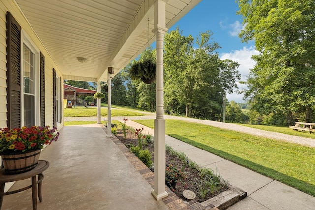 345 Big Spring Hollow Rd, Pulaski, TN 38478 - covered porch featuring a lawn and view of scattered trees