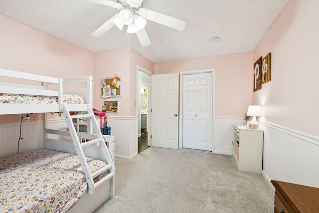 345 Big Spring Hollow Rd, Pulaski, TN 38478 - carpeted bedroom with wainscoting, a ceiling fan, a closet, and a textured ceiling