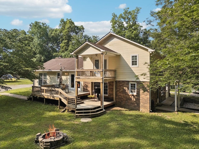 345 Big Spring Hollow Rd, Pulaski, TN 38478 - back of house featuring a fire pit, a lawn, and a wooden deck