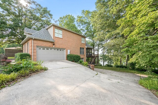 208 Loop Dr, Winchester, TN 37398 - view of front of house featuring concrete driveway, brick siding, a garage, and a shingled roof
