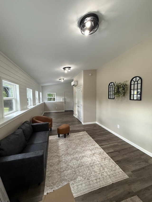 209 Franklin Park, Winchester, TN 37398 - living room featuring healthy amount of natural light, dark wood-style floors, vaulted ceiling, and a wall mounted air conditioner