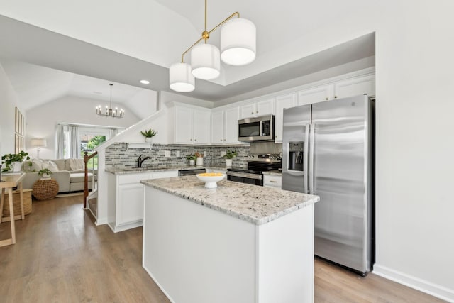3065 Sakari Cir, Spring Hill, TN 37174 - kitchen featuring stainless steel appliances, lofted ceiling, white cabinets, tasteful backsplash, and a sink