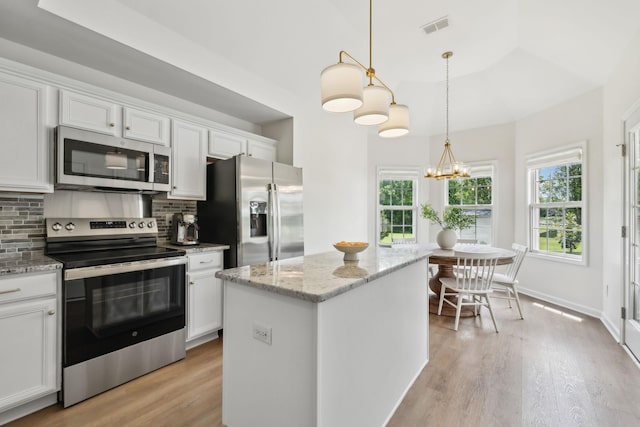 3065 Sakari Cir, Spring Hill, TN 37174 - kitchen featuring appliances with stainless steel finishes, light wood finished floors, and decorative backsplash