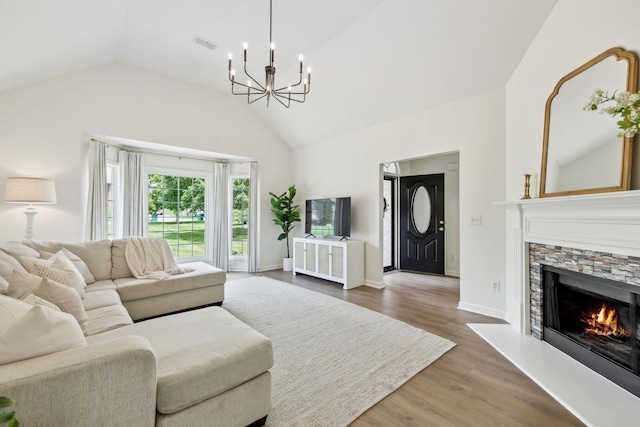 3065 Sakari Cir, Spring Hill, TN 37174 - living area featuring a chandelier, vaulted ceiling, dark wood-style flooring, a fireplace, and baseboards