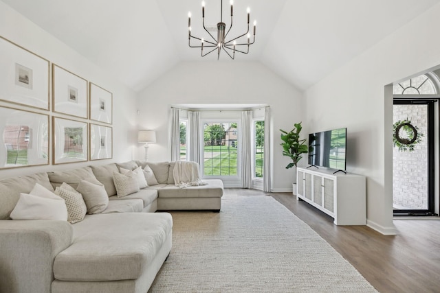 3065 Sakari Cir, Spring Hill, TN 37174 - living room featuring a chandelier, dark wood finished floors, lofted ceiling, and baseboards