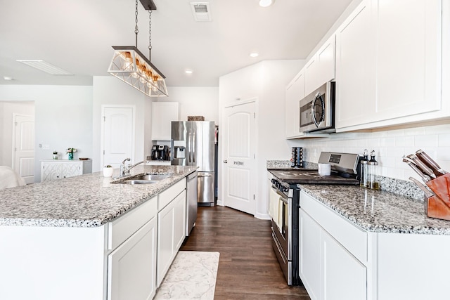 8024 Craighead Dr, Lebanon, TN 37087 - kitchen with appliances with stainless steel finishes, tasteful backsplash, light stone countertops, dark wood finished floors, and recessed lighting