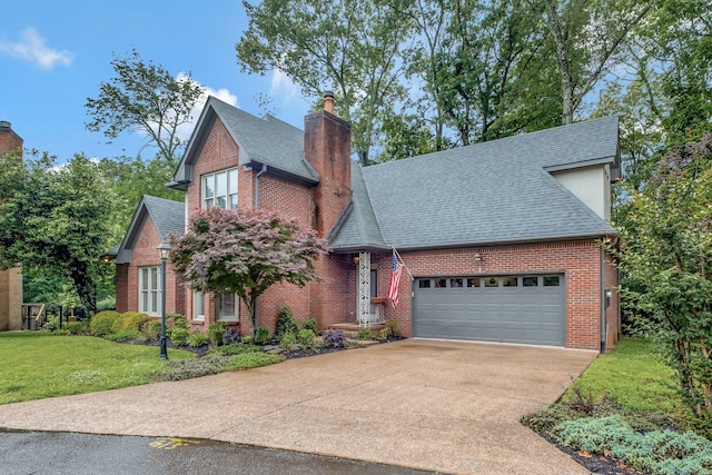 317 Ketch Cv, Hermitage, TN 37076 - view of front of property featuring roof with shingles, a chimney, brick siding, a front lawn, and concrete driveway
