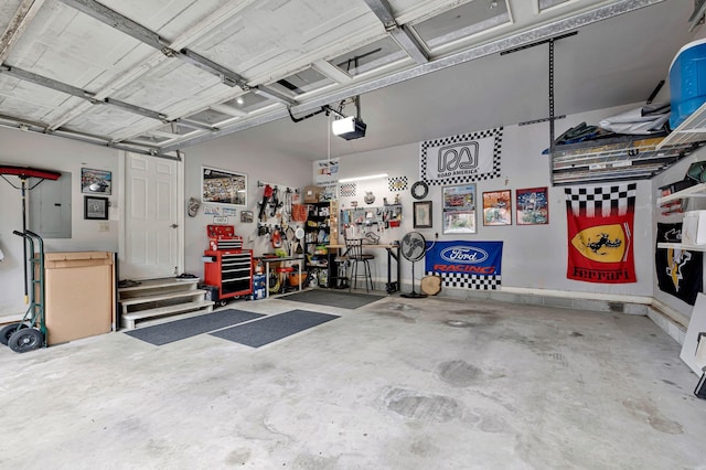 317 Ketch Cv, Hermitage, TN 37076 - garage featuring a garage door opener, electric panel, and a workshop area