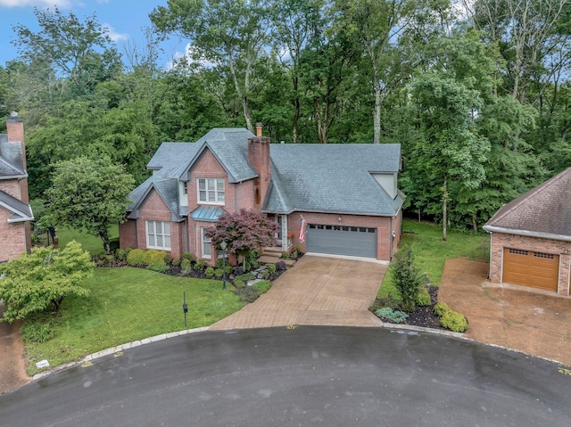 317 Ketch Cv, Hermitage, TN 37076 - view of front facade with brick siding, a shingled roof, a chimney, an attached garage, and a front lawn