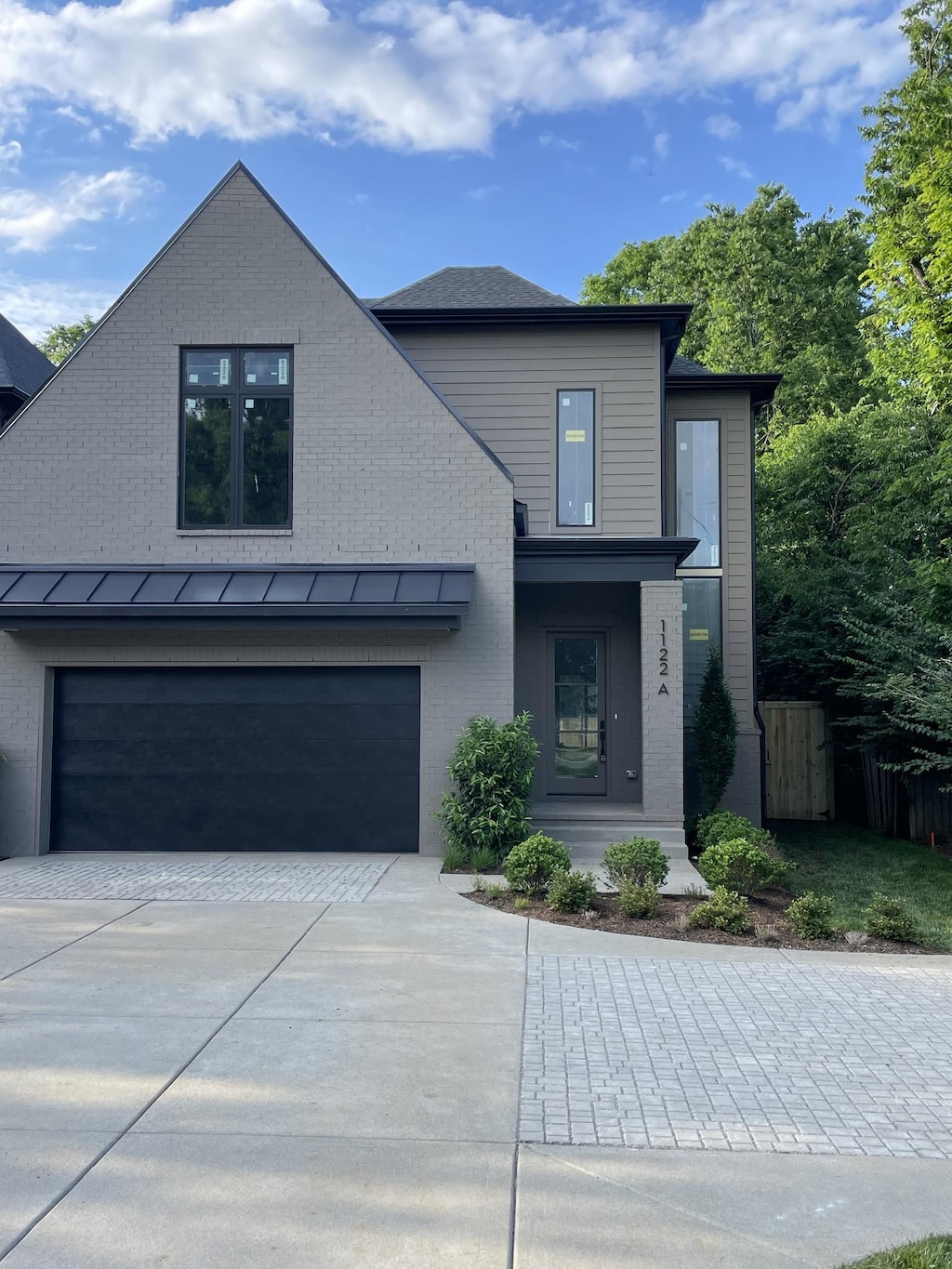 1122A Biltmore Dr, Nashville, TN 37204 - view of front of home featuring a garage, brick siding, driveway, and a standing seam roof