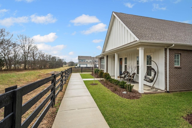 1308 Belgove Aly, Antioch, TN 37013 - view of home's exterior featuring board and batten siding, roof with shingles, brick siding, and a patio area