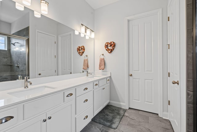 1308 Belgove Aly, Antioch, TN 37013 - bathroom with double vanity, a tile shower, marble look tile flooring, and baseboards