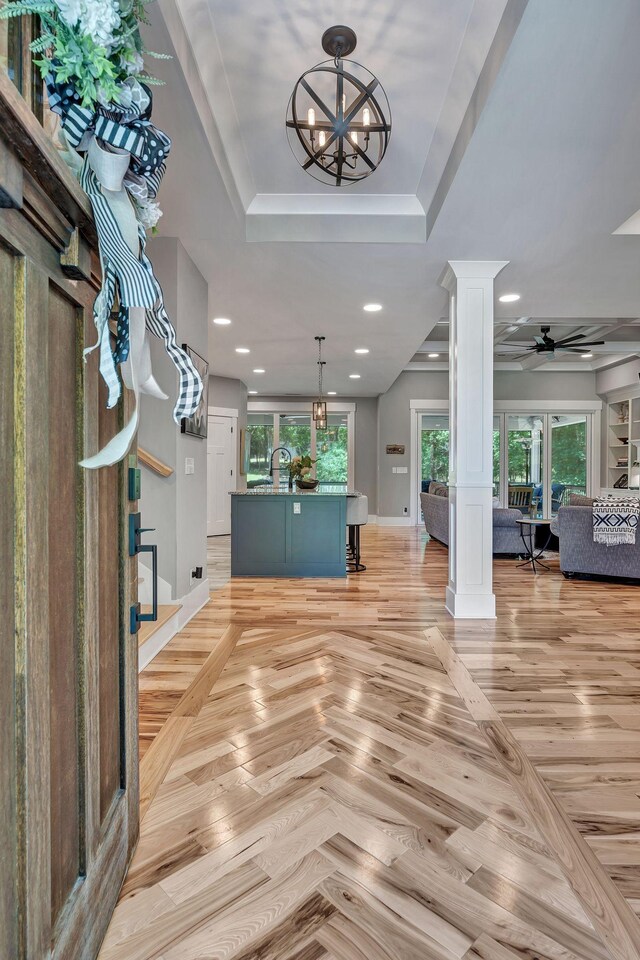 2670 Morgan Rd, Joelton, TN 37080 - entryway featuring decorative columns, a raised ceiling, a chandelier, ceiling fan, and baseboards