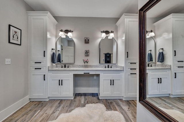 2670 Morgan Rd, Joelton, TN 37080 - bathroom with double vanity, wood finished floors, and baseboards
