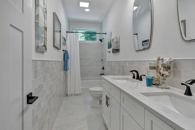 2670 Morgan Rd, Joelton, TN 37080 - full bath featuring tile walls, shower / bath combination with curtain, toilet, double vanity, and a wainscoted wall