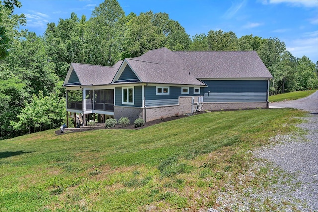 2670 Morgan Rd, Joelton, TN 37080 - view of front of home with a sunroom, brick siding, a front yard, and a shingled roof