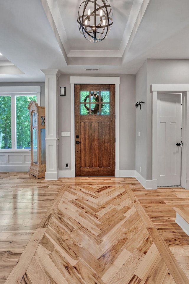 2670 Morgan Rd, Joelton, TN 37080 - foyer entrance with a tray ceiling, a chandelier, baseboards, and parquet floors