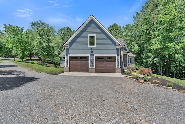 2670 Morgan Rd, Joelton, TN 37080 - view of front of house featuring brick siding, gravel driveway, and an attached garage