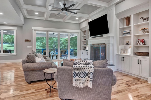 2670 Morgan Rd, Joelton, TN 37080 - living room featuring a ceiling fan, plenty of natural light, a lit fireplace, light wood-type flooring, and beam ceiling