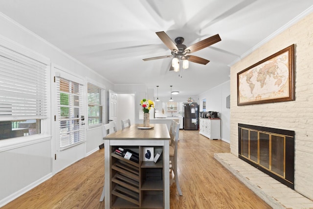 916 Lion Pkwy, Columbia, TN 38401 - kitchen with freestanding refrigerator, crown molding, light wood-style flooring, ceiling fan, and baseboards