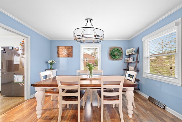 916 Lion Pkwy, Columbia, TN 38401 - dining space featuring a chandelier, wood finished floors, crown molding, and baseboards