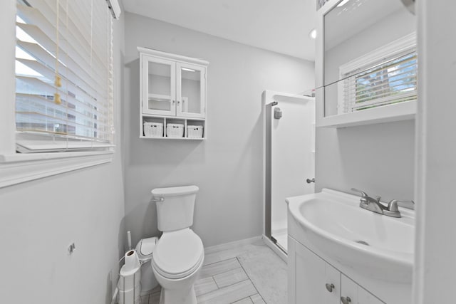 916 Lion Pkwy, Columbia, TN 38401 - bathroom featuring a stall shower, toilet, vanity, and baseboards