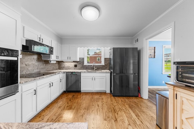 916 Lion Pkwy, Columbia, TN 38401 - kitchen with black appliances, a sink, light wood-style flooring, white cabinets, and crown molding