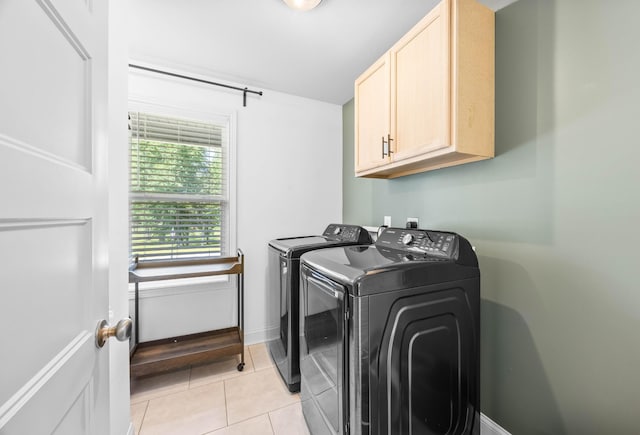 800 Snapdragon Ct, Clarksville, TN 37042 - laundry room featuring cabinet space, washing machine and clothes dryer, light tile patterned flooring, and baseboards