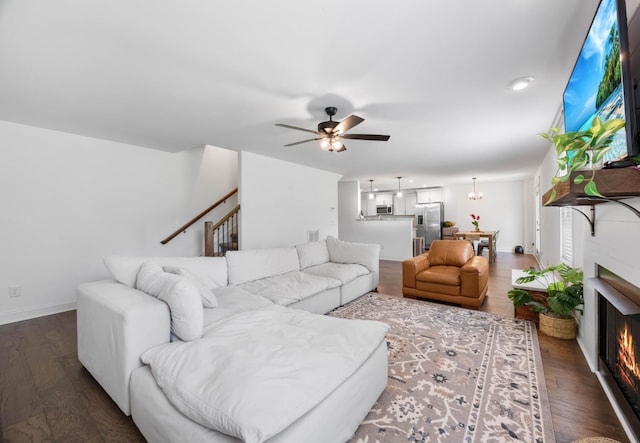 800 Snapdragon Ct, Clarksville, TN 37042 - living area with a ceiling fan, dark wood-type flooring, a lit fireplace, and baseboards