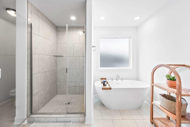 800 Snapdragon Ct, Clarksville, TN 37042 - bathroom with a stall shower, a freestanding tub, tile patterned floors, toilet, and baseboards