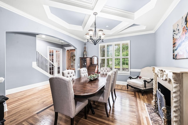 3009 Burnley Ct, Spring Hill, TN 37174 - dining area with arched walkways, a chandelier, wood finished floors, a high end fireplace, and crown molding