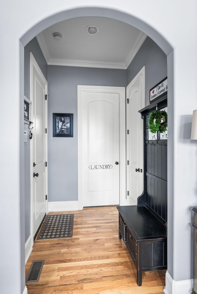 3009 Burnley Ct, Spring Hill, TN 37174 - mudroom featuring light wood-type flooring, crown molding, arched walkways, and baseboards