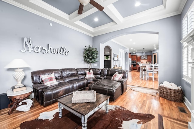 3009 Burnley Ct, Spring Hill, TN 37174 - living room featuring arched walkways, light wood-type flooring, ceiling fan, beam ceiling, and crown molding
