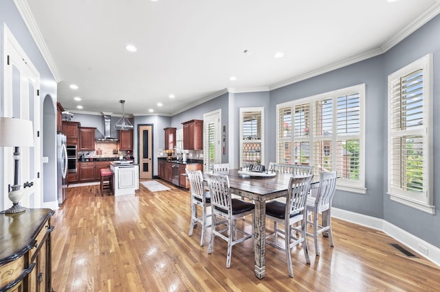 3009 Burnley Ct, Spring Hill, TN 37174 - dining area featuring light wood-style flooring, recessed lighting, crown molding, and baseboards