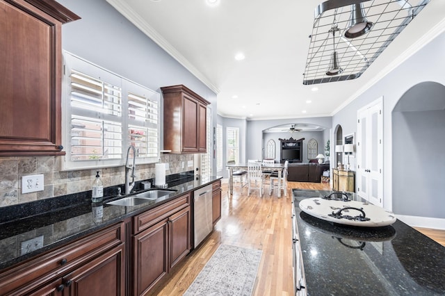3009 Burnley Ct, Spring Hill, TN 37174 - kitchen with arched walkways, a sink, stainless steel dishwasher, light wood-style floors, and crown molding