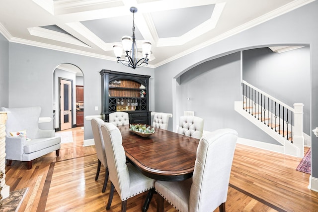 3009 Burnley Ct, Spring Hill, TN 37174 - dining area featuring arched walkways, a chandelier, stairs, crown molding, and light wood-style flooring