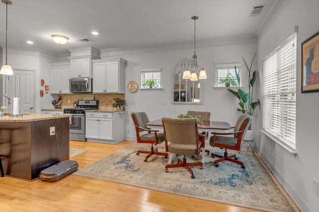 1144 Frewin St, Nolensville, TN 37135 - dining room with light wood finished floors, a chandelier, ornamental molding, recessed lighting, and baseboards