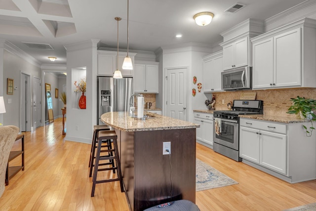 1144 Frewin St, Nolensville, TN 37135 - kitchen featuring appliances with stainless steel finishes, a sink, a kitchen breakfast bar, light wood-style floors, and recessed lighting