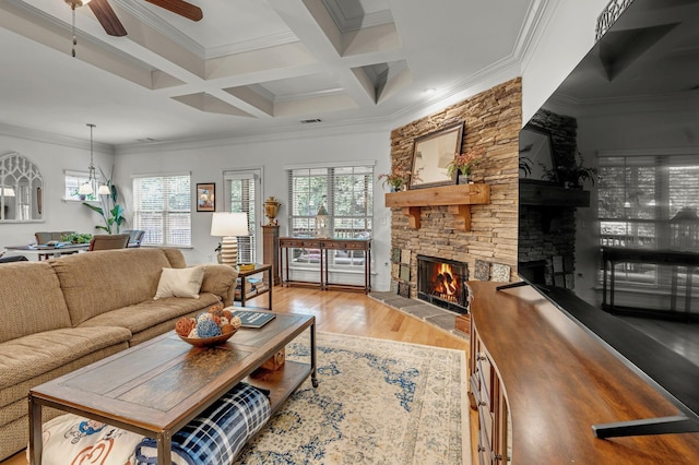 1144 Frewin St, Nolensville, TN 37135 - living area featuring a fireplace, ceiling fan, light wood finished floors, crown molding, and beamed ceiling