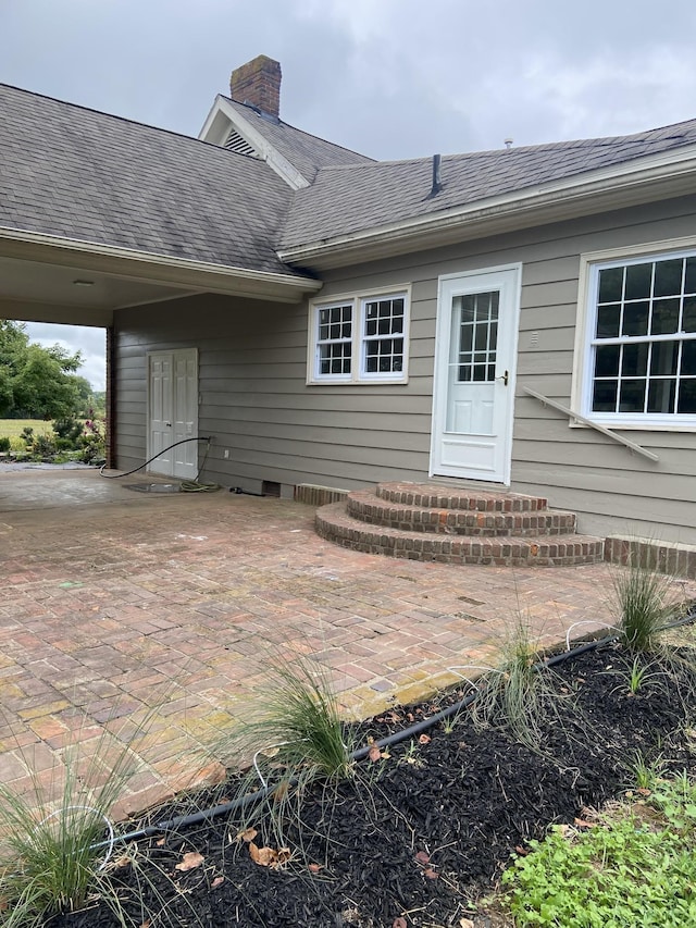 11495 Guthrie Rd, Guthrie, KY 42234 - entrance to property featuring a chimney, a patio area, and a shingled roof