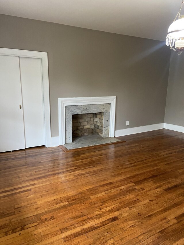 11495 Guthrie Rd, Guthrie, KY 42234 - unfurnished living room featuring hardwood / wood-style floors, baseboards, and a high end fireplace