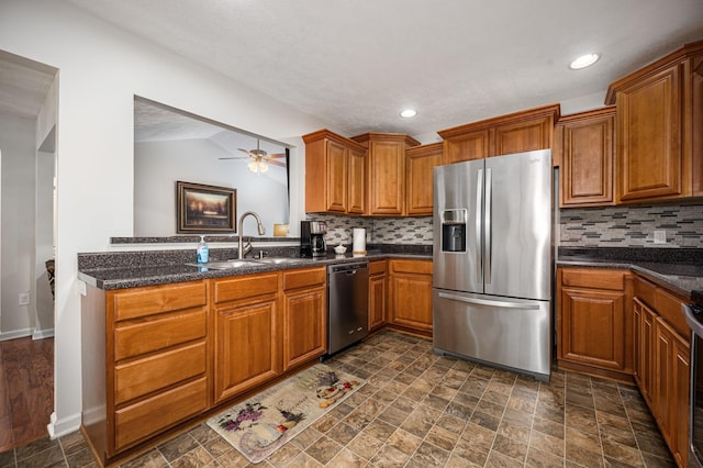 2480 Mount Lebanon Rd, Lewisburg, TN 37091 - kitchen with stainless steel appliances, a sink, brown cabinetry, backsplash, and vaulted ceiling