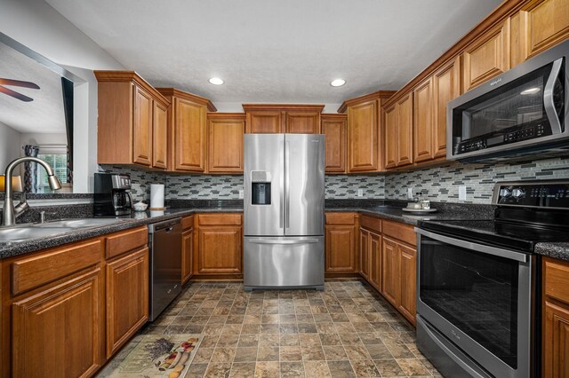 2480 Mount Lebanon Rd, Lewisburg, TN 37091 - kitchen with appliances with stainless steel finishes, a sink, brown cabinetry, decorative backsplash, and recessed lighting